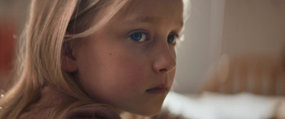 a close up of a child's face with a blurry background