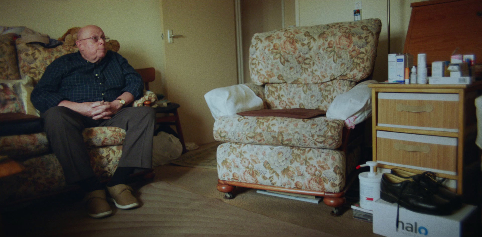 a man sitting in a chair in a living room