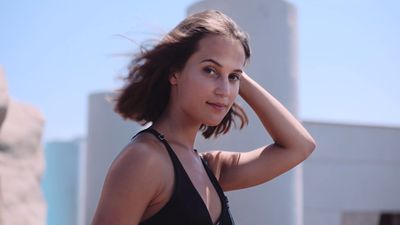 a woman in a black top posing for a picture