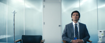 a man in a suit and tie standing in a room