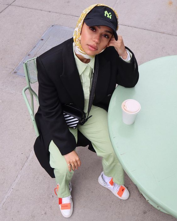 a person sitting at a table with a hat on