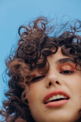 a close up of a woman with curly hair