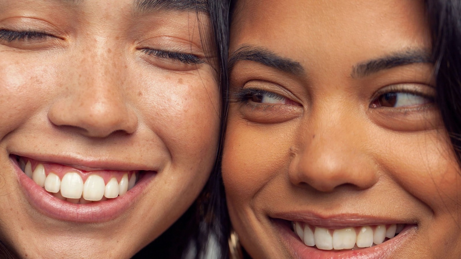 a close up of two women smiling for the camera