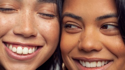 a close up of two women smiling for the camera