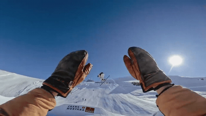 a person standing on top of a snow covered slope