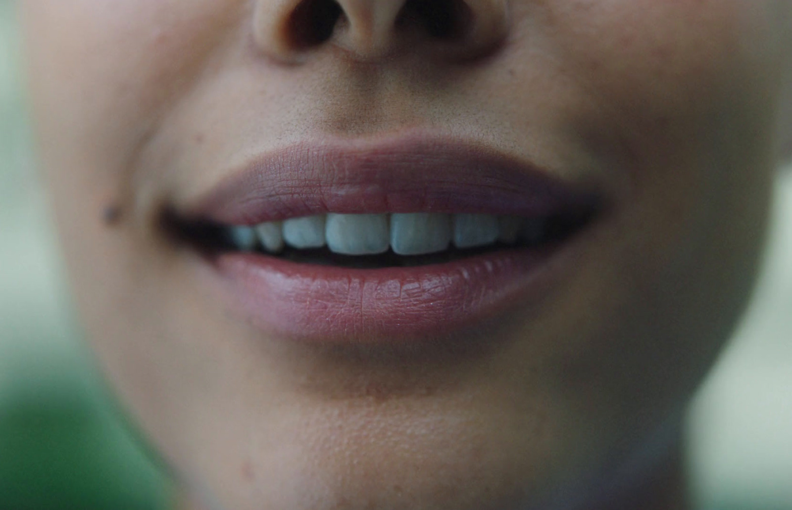 a close up of a woman's mouth with a missing tooth