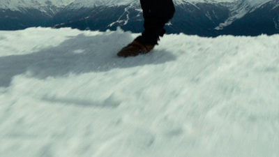 a person standing on a snowboard in the snow