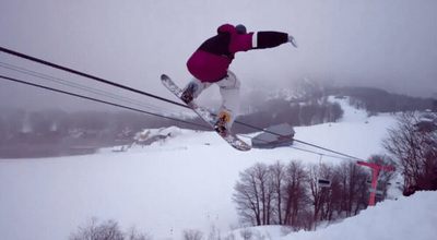 a person on a snowboard jumping in the air