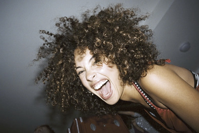 a woman with an open mouth and curly hair