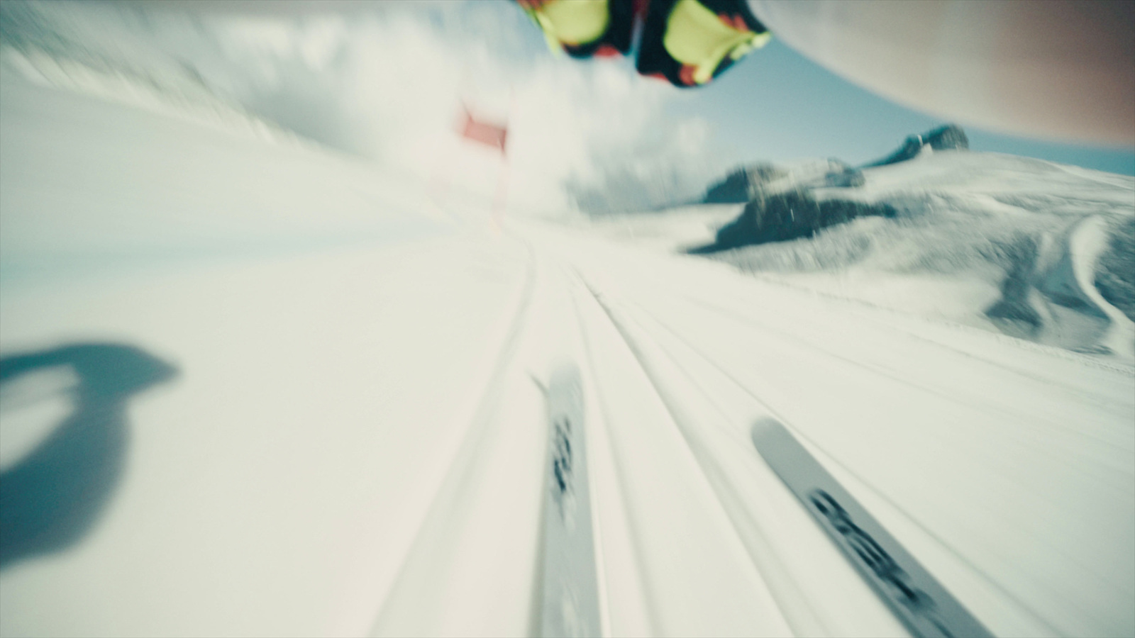 a person flying a kite on top of a snow covered slope