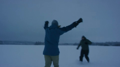 a couple of people that are standing in the snow