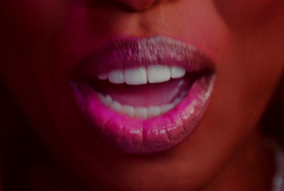 a close up of a woman's mouth with pink lipstick