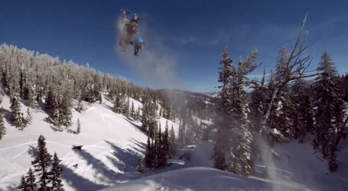 a person jumping a snow board in the air