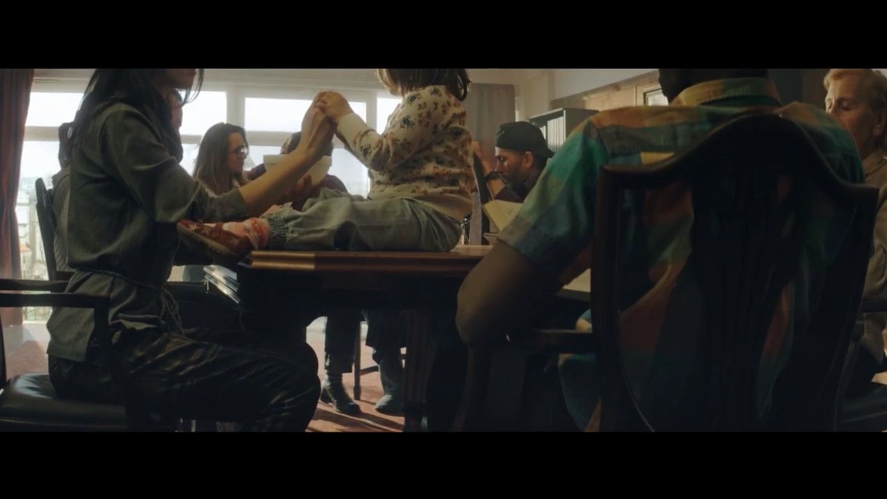 a group of people sitting around a wooden table