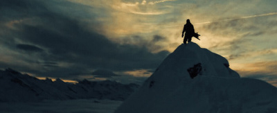 a man standing on top of a snow covered mountain