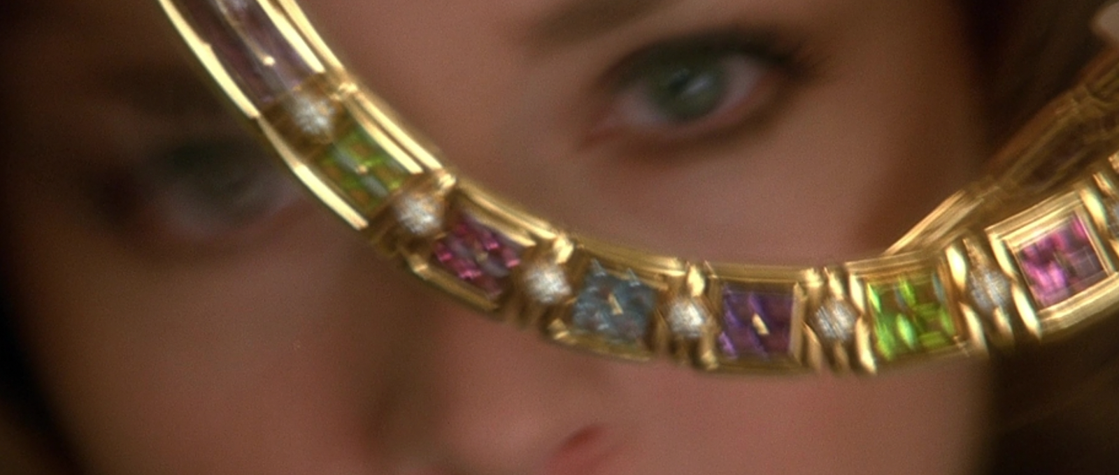 a close up of a woman's face looking through a magnifying glass