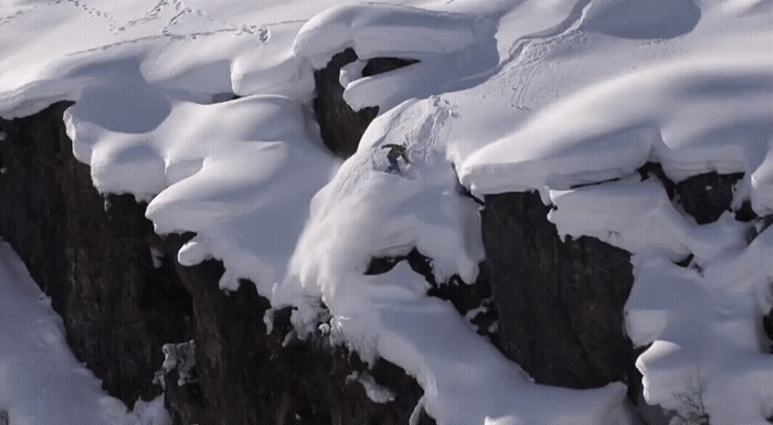 a person skiing down a mountain covered in snow