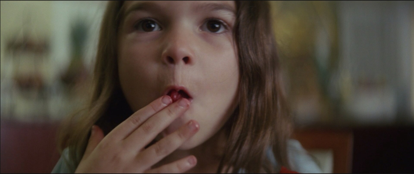 a young girl with her hands in her mouth