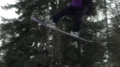 a person on a snowboard jumping in the air