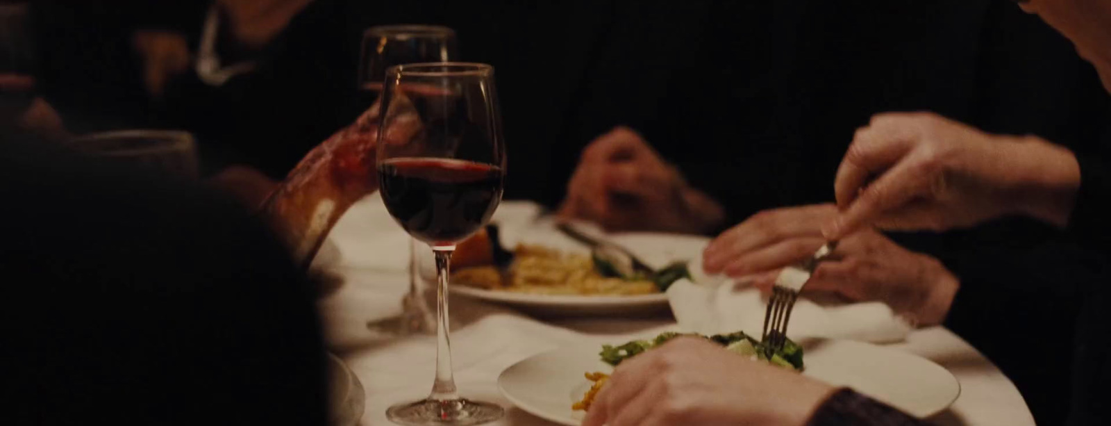 a group of people sitting around a table eating food