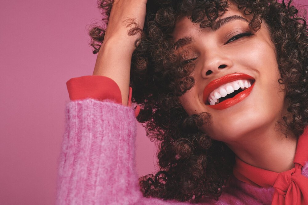 a close up of a woman with curly hair