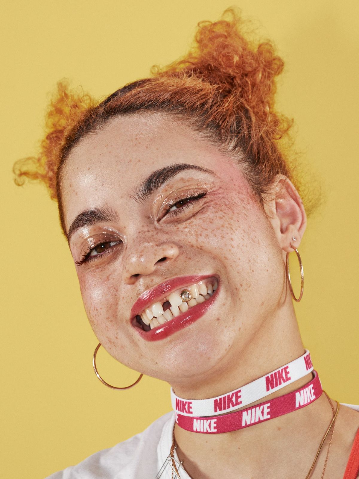 a woman with freckled hair wearing a neck tie