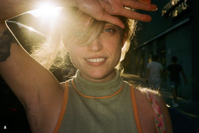 a close up of a person touching their hair