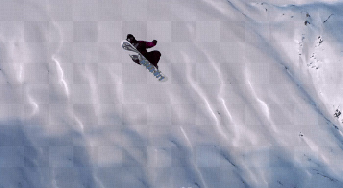 a person on a snowboard in the snow