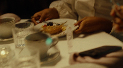 a group of people sitting at a table with plates of food