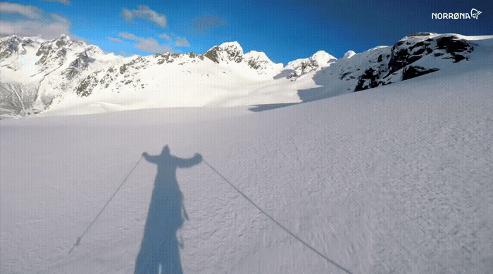 a shadow of a skier on a snowy mountain