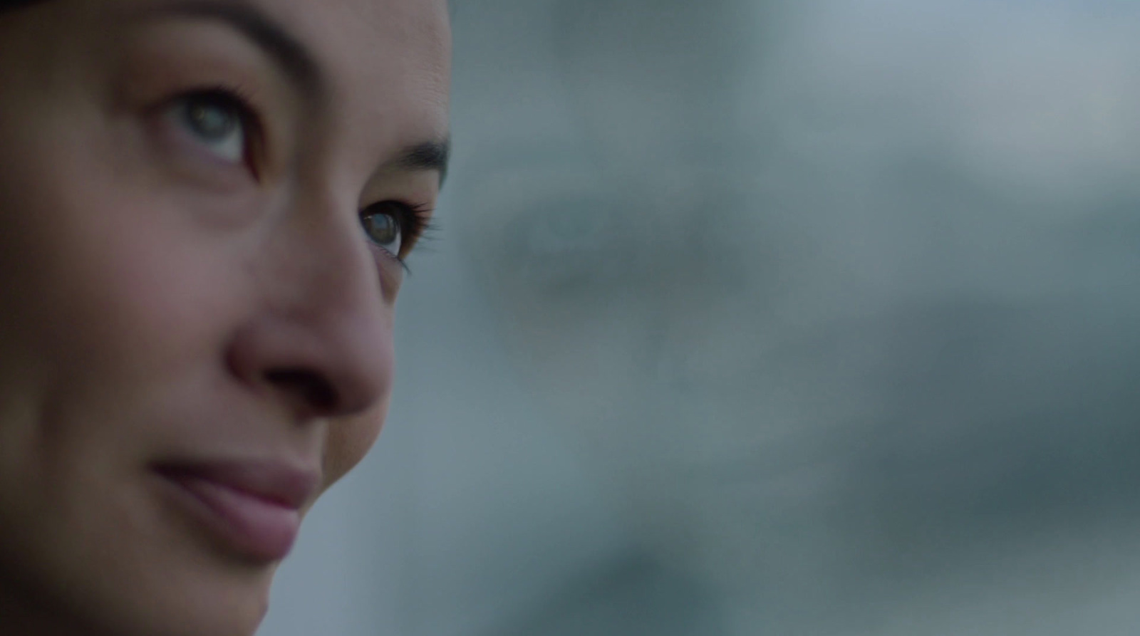 a close up of a woman's face with a blurry background