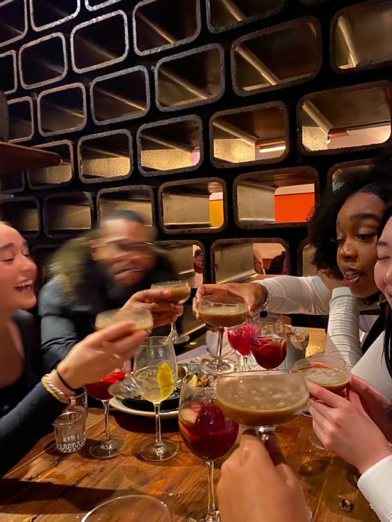 a group of people sitting around a wooden table