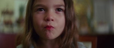 a little girl making a funny face with her tongue