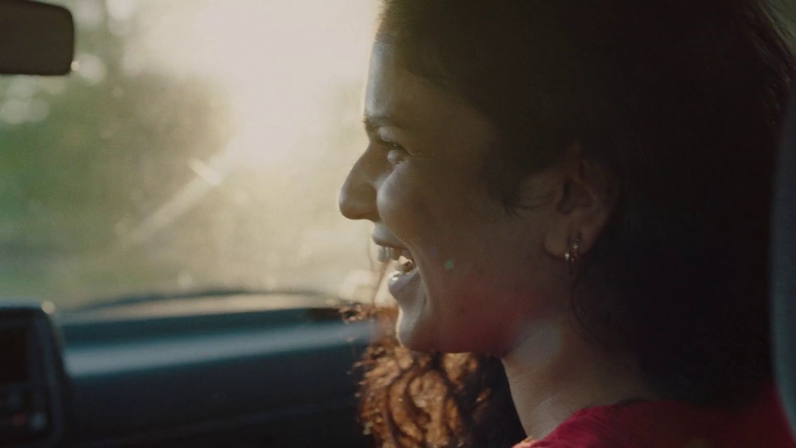 a woman sitting in the passenger seat of a car