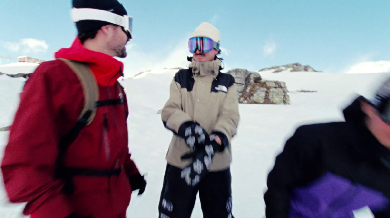 a group of people standing on top of a snow covered slope