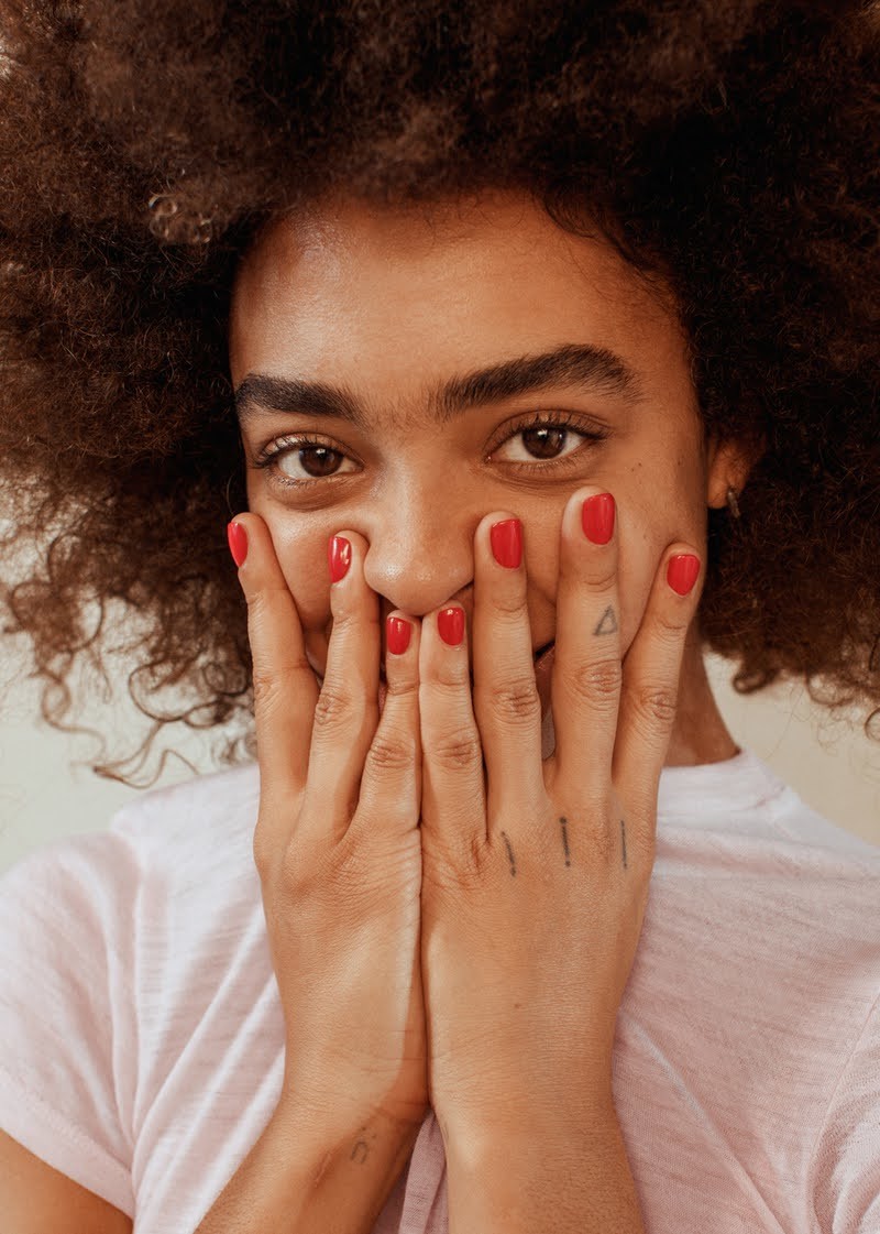 a woman covering her face with her hands