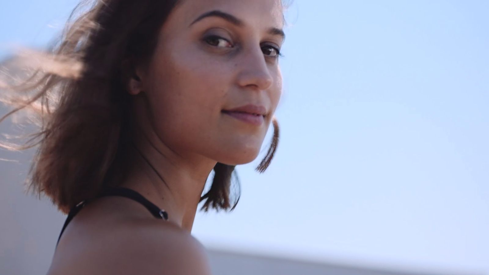 a close up of a person with a sky background