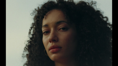 a close up of a woman with curly hair