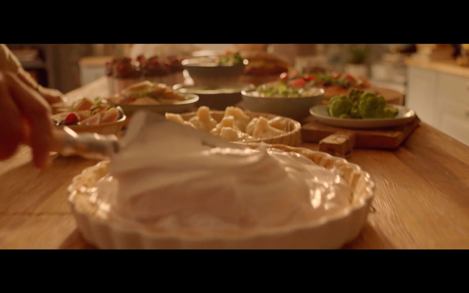 a wooden table topped with bowls of food