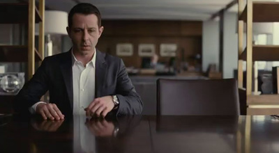 a man in a suit sitting at a table