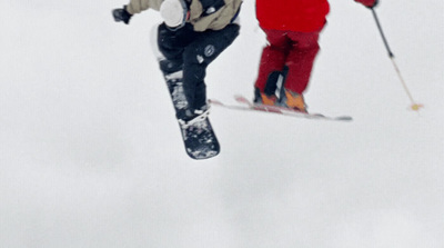 a couple of people on skis jumping in the air