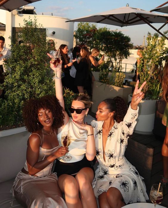 a group of women sitting on top of a roof