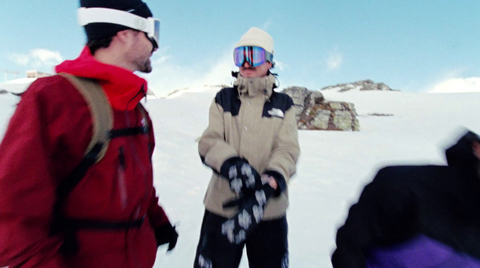 a group of people standing on top of a snow covered slope