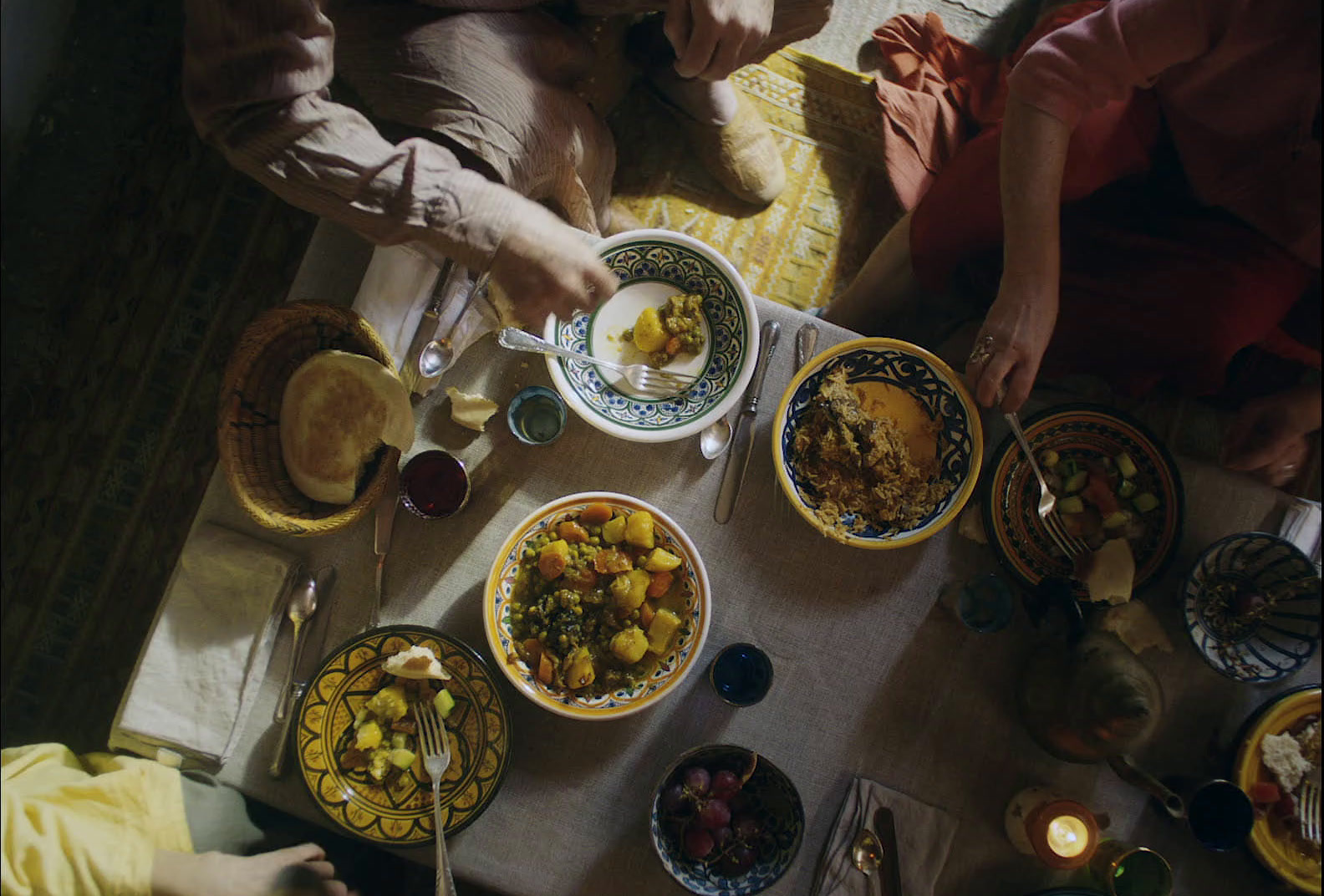 a group of people sitting around a table eating food