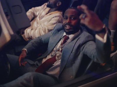 a man in a suit and tie sitting in a car