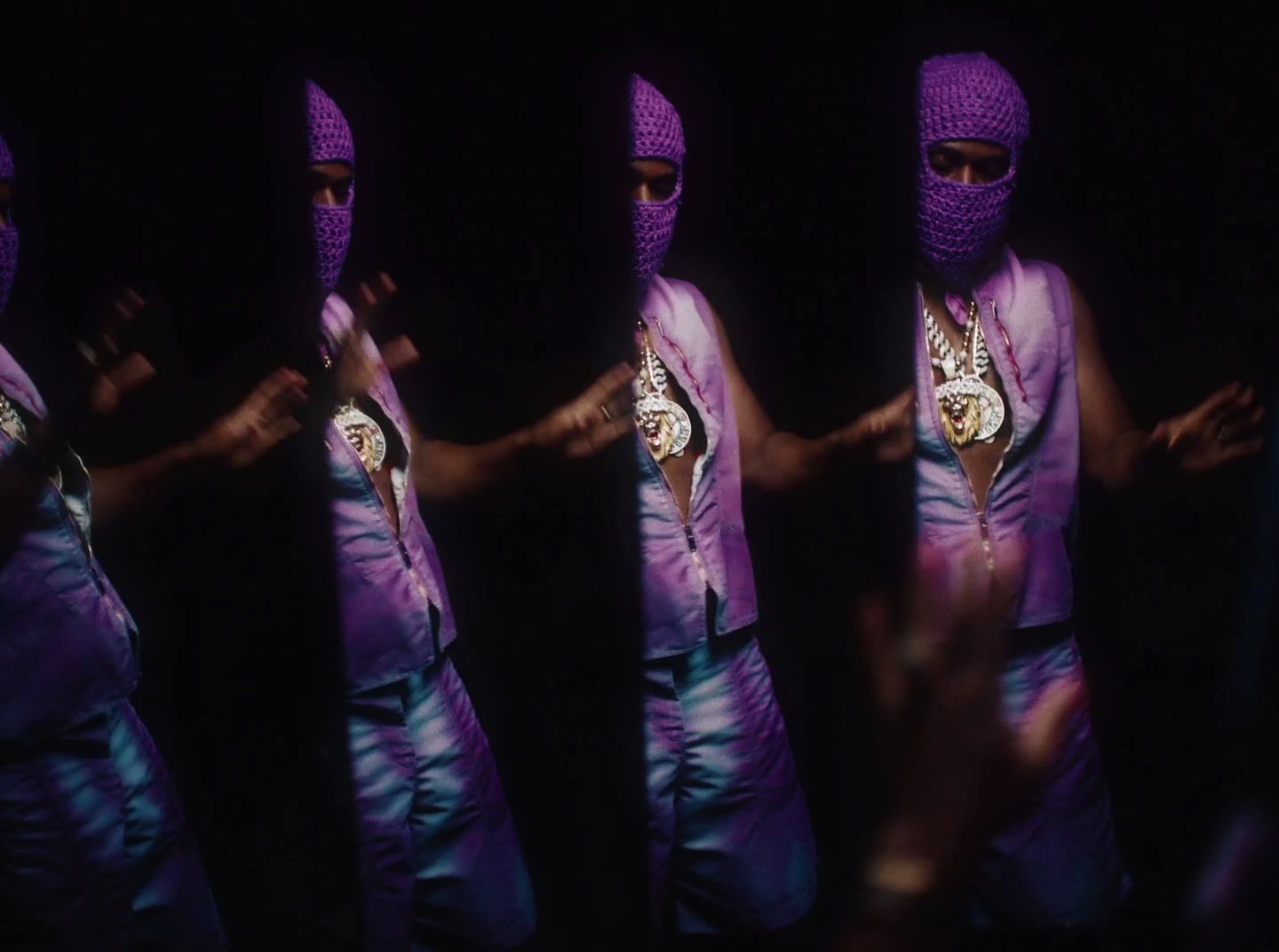 a person wearing a purple outfit and a purple mask