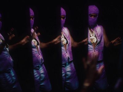 a person wearing a purple outfit and a purple mask