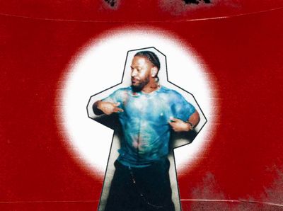 a picture of a man standing in front of a red wall