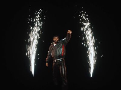 a man standing in front of two fireworks