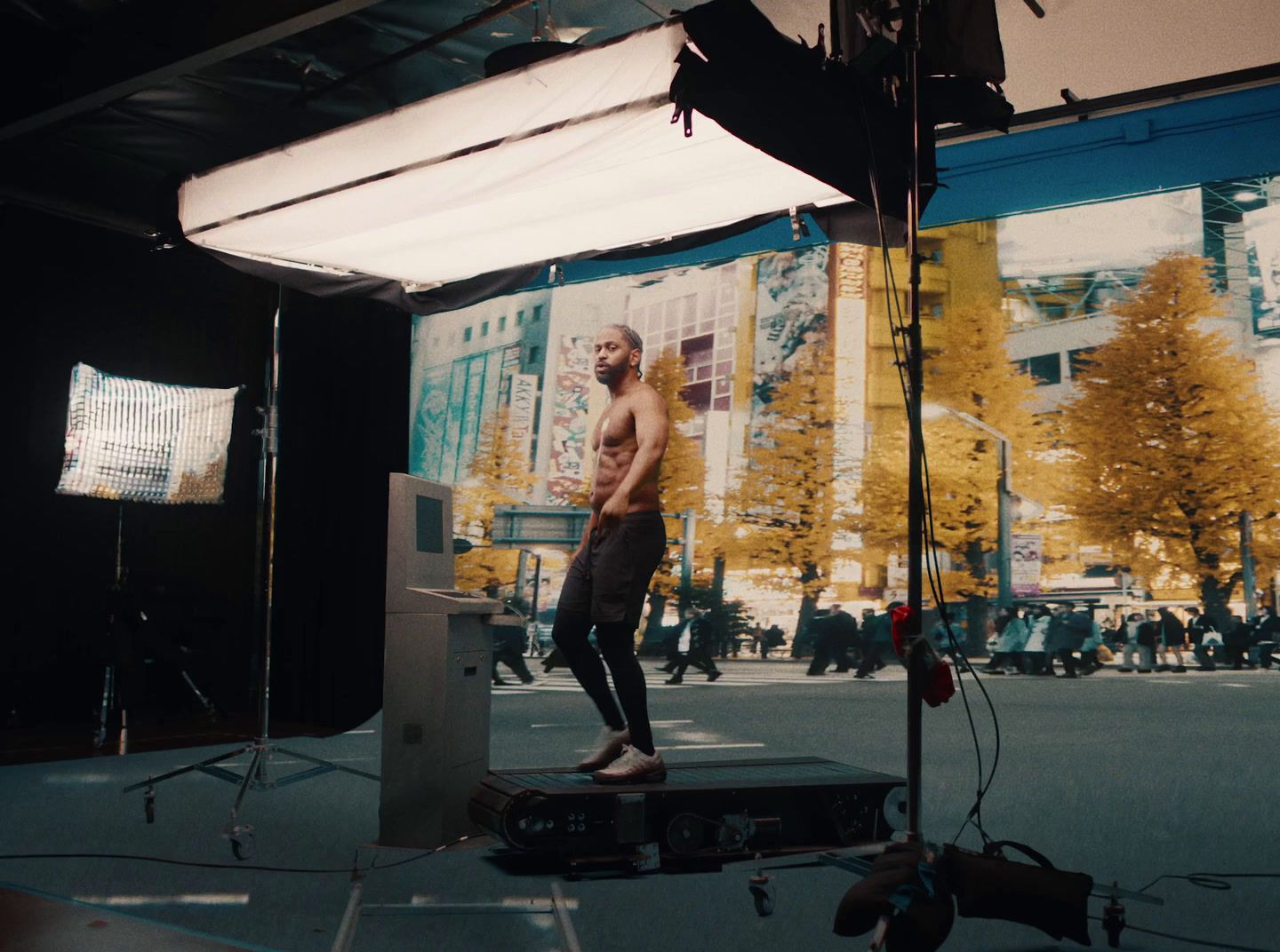 a man standing on top of a box in front of a camera